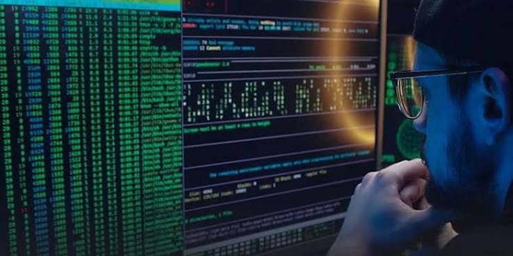 Developer workspace with screens, code overlays, and a tablet interface.